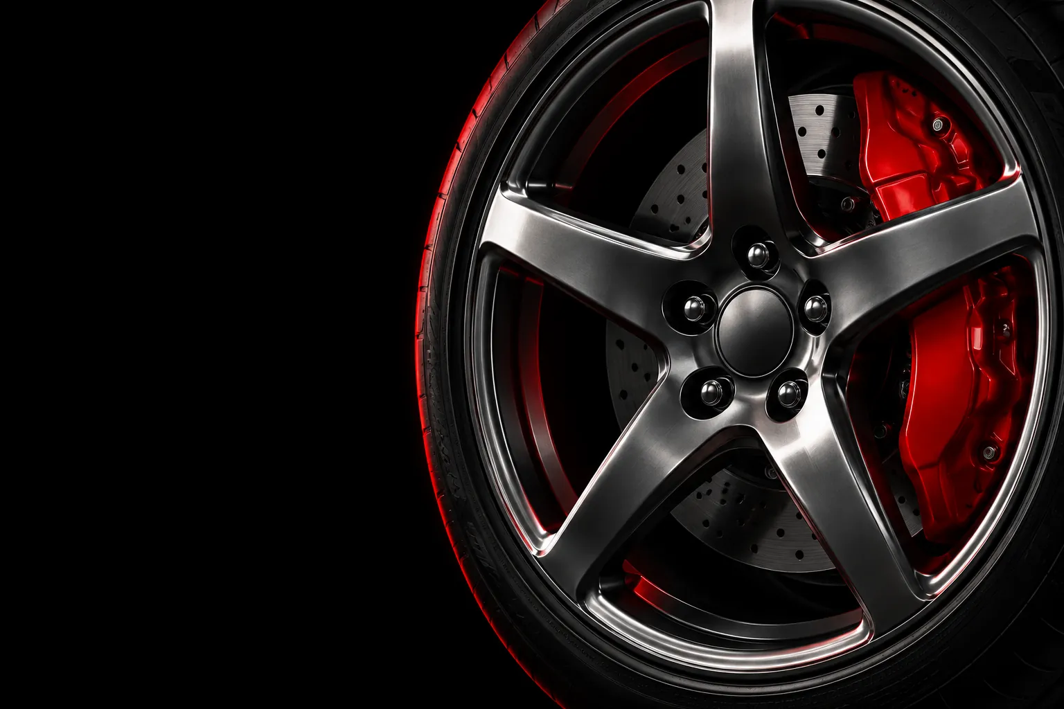 Gunmetal five-spoke wheel with a red brake caliper